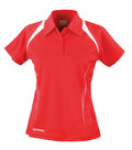 Spiro's S177F sports polo shirt is red with white accents on the shoulders and sides, featuring a collar, short sleeves, and a button-up design. The Spiro brand name is printed on both the front and back of the collar.