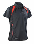 The Spiro S177M is a dark gray polo shirt with red accents on the shoulders and sides, featuring a collar and short sleeves.
