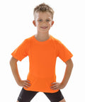 A young boy with short hair stands confidently with hands on hips, wearing a Spiro S287J and black shorts.