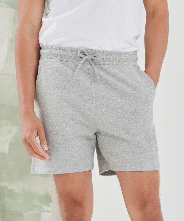 A person wearing a white SF t-shirt and gray SF432 drawstring shorts stands with their hands in their pockets.