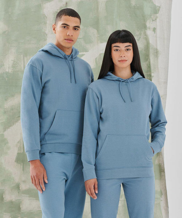 Two people stand side by side wearing matching light blue SF SF531 hooded sweatshirts and pants against a green and white abstract background.