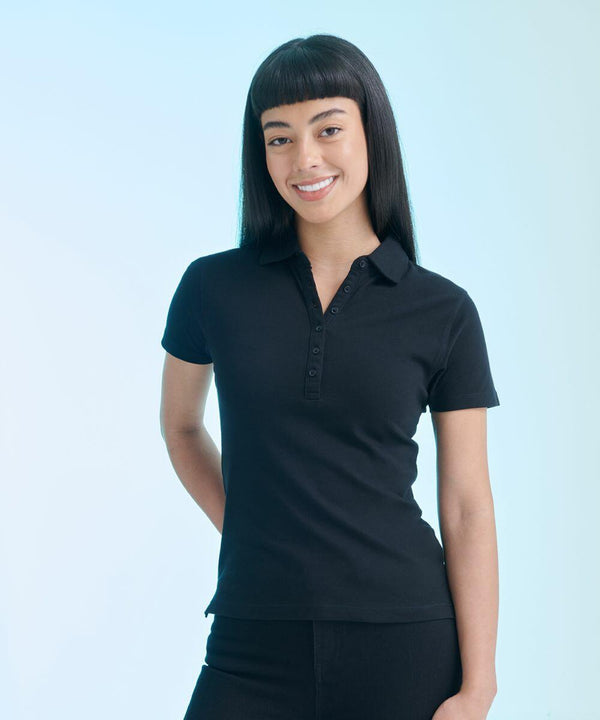 A person with long, straight hair and bangs is smiling, wearing a black polo shirt and standing against a light blue background. They are holding the SF SK042.