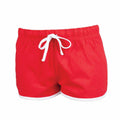 SK069 by Skinnifit are red athletic shorts featuring a white drawstring and white trim at the hem, complete with an elastic waistband.