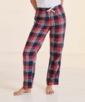 Person wearing SF SK083 red, white, and blue plaid pajama pants with a white drawstring, standing on a light-colored wooden floor.