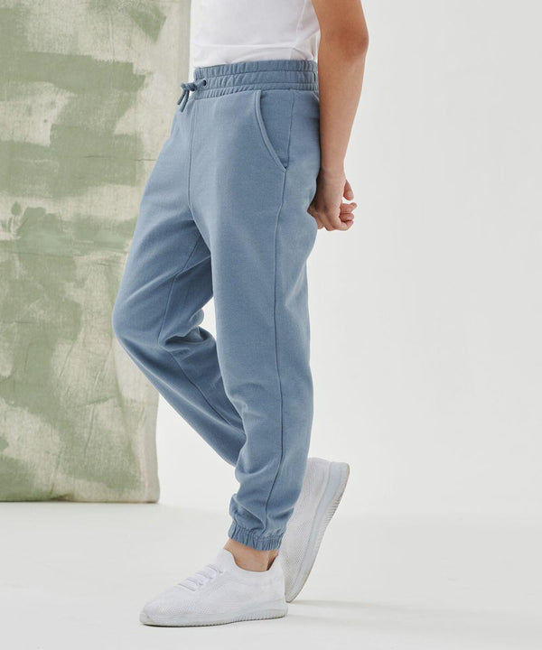 Person in blue SF Minni SM430 and white sneakers standing sideways against a light background.