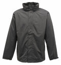 A Regatta Professional SN100 rain jacket in solid black, featuring a high collar and long sleeves, displayed against a white background. It comes with a full zipper concealed by a flap for enhanced rain protection.