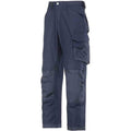 Snickers Navy blue cargo pants featuring multiple pockets, reinforced knees, and belt loops. The Snickers X_SN3214 pants have a relaxed fit and a zippered fly with a button closure. Suitable for work or casual wear.