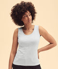 Person with curly hair wearing a Fruit of the Loom SS051 light grey sleeveless top, standing against a beige background.