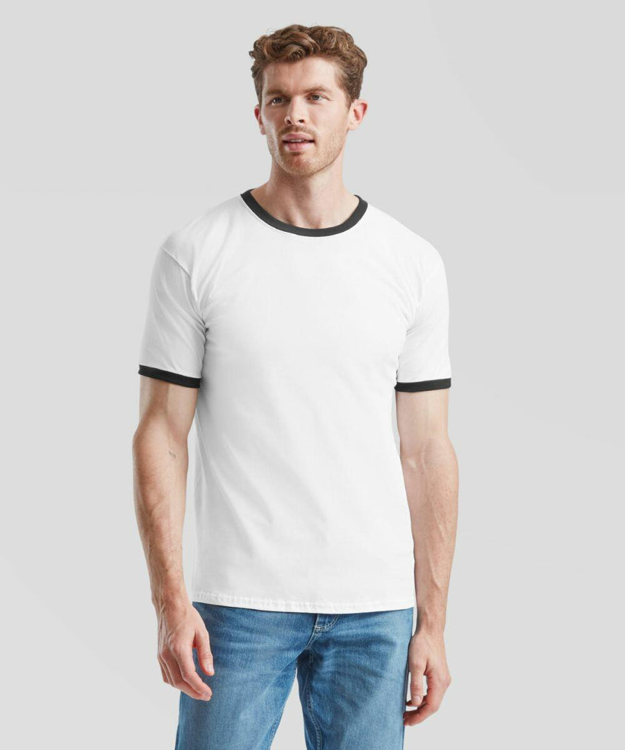 A man wearing a white Fruit of the Loom SS168 t-shirt with black trim and blue jeans stands against a plain gray background.