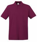 The Fruit of the Loom SS255 is a plain maroon polo shirt featuring short sleeves and a three-button placket, displayed against a white background.