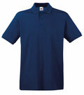 The Fruit of the Loom SS255 is a navy blue polo shirt featuring short sleeves and a collar, with a three-button placket and a discreet logo tag inside. The fabric looks smooth and durable.