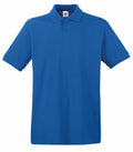 The SS255, a plain blue polo shirt from Fruit of the Loom, has short sleeves and a collar. It includes three buttons and a small brand label at the neckline. The shirt is showcased against a solid white background.