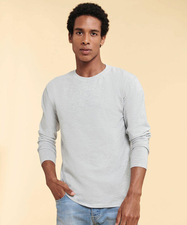 A person standing against a plain background, wearing a long-sleeve, light gray Fruit of the Loom SS434 shirt and blue jeans.