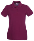 This is a Fruit of the Loom SS505, a maroon polo shirt featuring short sleeves, a collar, and three buttons centered at the top. The shirt is showcased against a plain white background.