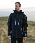 A man with short hair wearing a Stormtech ST011 jacket stands outdoors near a body of water.