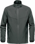The Stormtech ST077 is a dark gray zip-up jacket featuring a high collar, geometric pattern, long sleeves, and a zippered chest pocket.