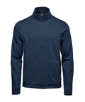 The Baselayers is a navy blue, full-zip jacket featuring a stand-up collar, long sleeves, and zipped side pockets, shown against a white background.