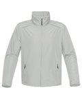 The Stormtech ST166 is a light gray windbreaker jacket featuring a high collar and a front zipper. It includes long sleeves and two zipped pockets on the front, crafted from smooth and lightweight fabric.