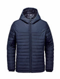The Stormtech ST212 is a dark blue puffer jacket with a hood, characterized by horizontal stitching and a front zipper closure.