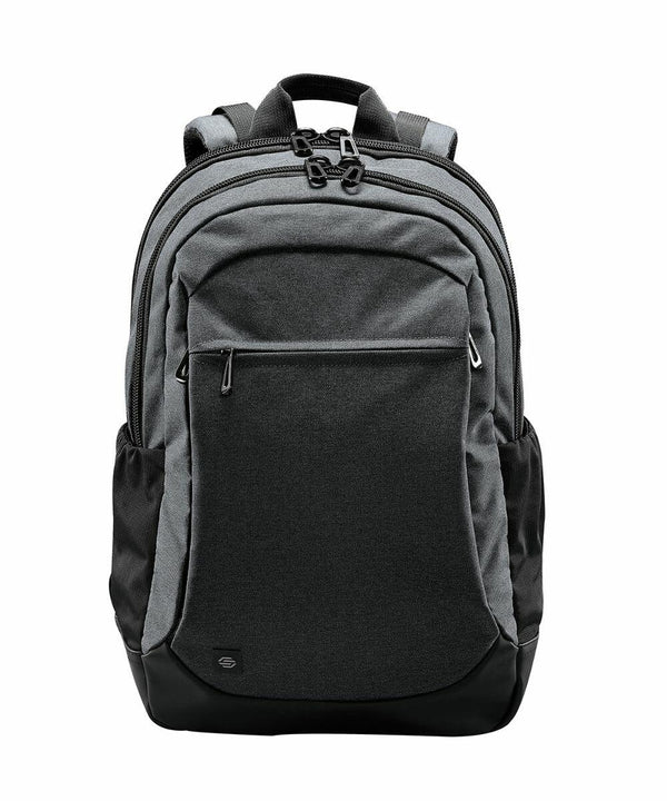 A gray Stormtech ST220 with multiple compartments, black zippers, and a front pocket. It has a handle on top and padded shoulder straps.