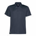 The ST669 by Stormtech is a dark gray short-sleeve polo shirt featuring a collar and three buttons, complemented by a small logo on the bottom left and a text logo adorning the right sleeve. The fabric looks smooth and lightweight.