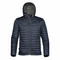The Stormtech ST803 is a dark blue, quilted puffer jacket with a high collar and hood. It includes practical features such as a front zipper, two side pockets, and a chest pocket. The interior of the hood is light gray. The jacket is showcased against a white background.