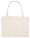 A plain beige canvas tote bag featuring long handles is presented against a white background. The SX062 by Stanley/Stella is empty and shown flat, with no visible designs or logos.
