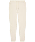 Beige joggers featuring an elasticated waistband with drawstring, two side pockets, and ribbed ankle cuffs, displayed flat on a white background.