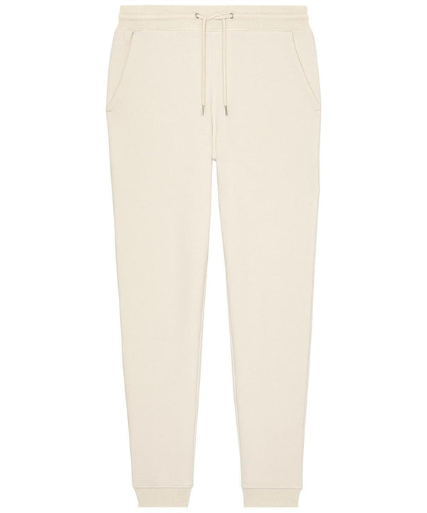 Beige joggers featuring an elasticated waistband with drawstring, two side pockets, and ribbed ankle cuffs, displayed flat on a white background.