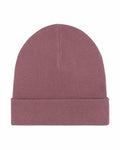 The Stanley/Stella SX146 beanie in a folded, plain dusty pink features a simple ribbed texture and a seamless design, centered against a white background.