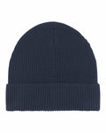 Introducing the SX147 by Stanley/Stella: a stylish navy blue beanie featuring a ribbed texture and a folded brim, showcased elegantly against a plain white backdrop.