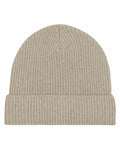 The SX147, a beige knit beanie by Stanley/Stella, features a ribbed texture and a folded brim, displayed on a white background.