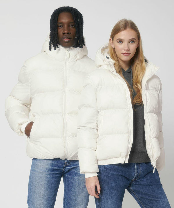 Two people standing side by side, both wearing white SX203 puffer jackets with hoods from Stanley/Stella, and blue jeans.