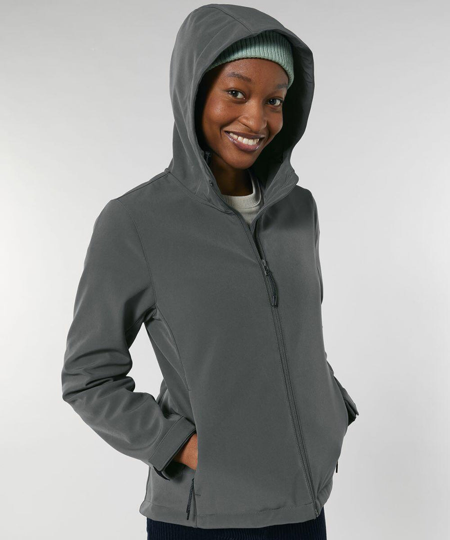 Person wearing a gray Stanley/Stella SX239 zip-up hoodie and a green beanie, smiling with hands in pockets against a plain background.