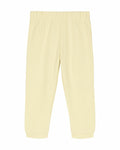 The Stanley/Stella SX767 pants in light yellow, featuring an elastic waistband and cuffed ankles, are laid flat on a white background.