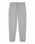 Stanley/Stella's SX773 gray sweatpants boast an elastic waistband with a drawstring, side pockets, and ankle cuffs, laid flat against a white background.