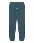 The Stanley/Stella SX773 jogger pants in dark teal feature an elastic waistband with a drawstring and cuffed ankles, offering a comfortable and casual look.