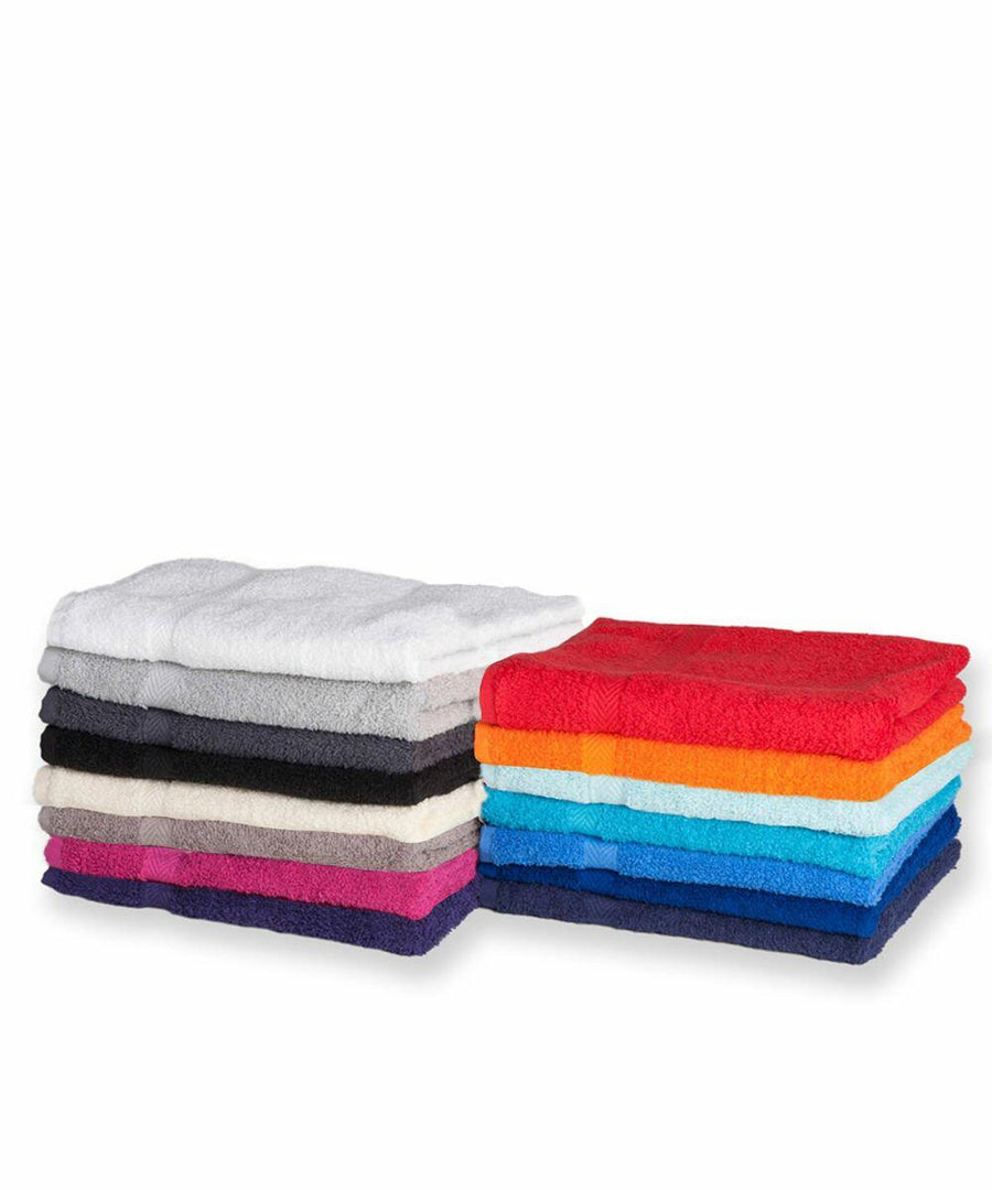 Stacked piles of neatly folded TC003 towels by Towel City in various colors, including white, gray, black, blue, orange, and red, against a plain white background.