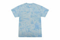 Displayed on a plain white background, the Colortone TD02M is a light blue tie-dye T-shirt featuring a white round neckline and a subtle cloud-like pattern with varying shades of blue.