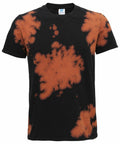 The shirt, model TD09M by Colortone, is a black T-shirt adorned with an orange tie-dye pattern showcasing irregular splatters on the front.