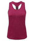 The TR027 tank top by Tri-Dri is a sleeveless racerback design in vibrant magenta. Made from smooth and lightweight fabric, it's crafted for both comfort and style. It features a round neckline and a fitted silhouette, making it ideal for casual or workout wear, with the size tag visible at the back.