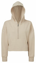 The TR077 by Tri-Dri is a beige hoodie featuring a half-zip front, long sleeves, and a convenient kangaroo pocket. The hood is styled up, and the fabric looks soft and comfortable.