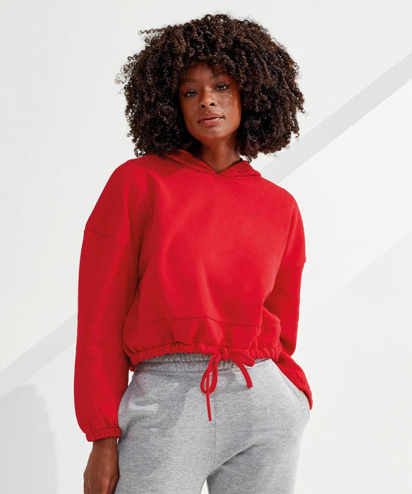 A person with curly hair wears a red Tri-Dri TR085 and gray sweatpants, standing against a white background.