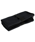 The TriDri microfibre quick-dry fitness towel by TriDri, folded and secured with a black elastic strap, is displayed on a white surface.
