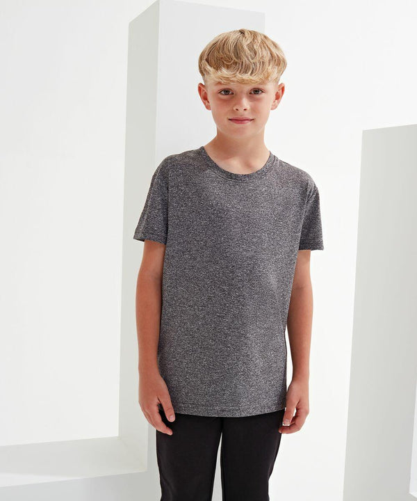 A boy with short blonde hair stands in front of a white background, wearing a gray Tri-Dri TR10B t-shirt and black pants.