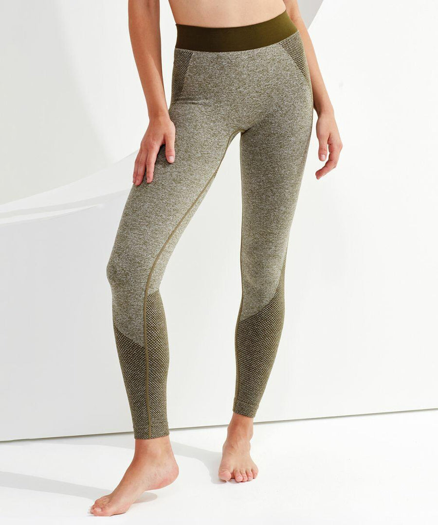 Person standing barefoot wearing Tri-Dri TR212 grey and olive green leggings with one hand resting on their thigh against a plain background.