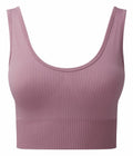 The Tri-Dri TR213, a mauve ribbed seamless sports bra with a scoop neckline, is displayed against a white background. The fabric features vertical ribbing and a stretchy band around the bottom for a snug fit.