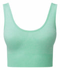 The TR213 from Tri-Dri is a mint green crop top featuring a ribbed texture, wide straps, and a scoop neckline. The fabric boasts a subtle texture, and the hem is slightly elasticated for added comfort.
