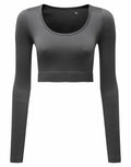 Introducing the Tri-Dri TR224: a gray, long-sleeved crop top featuring a scoop neckline, beautifully showcased against a simple backdrop.