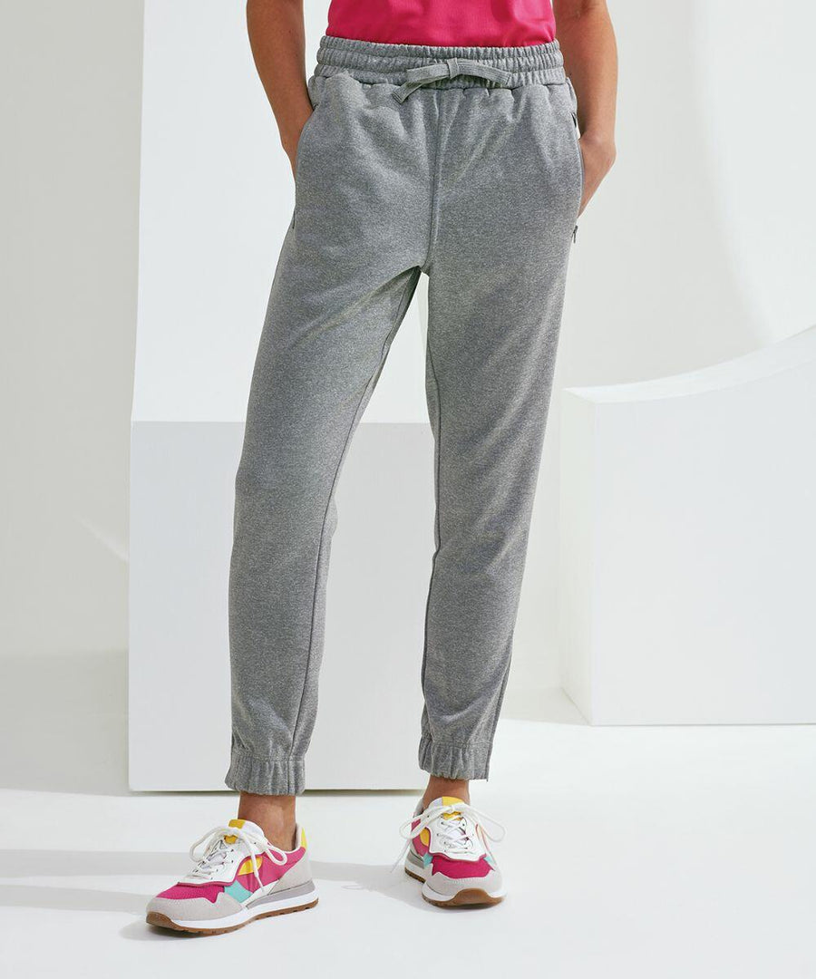 A person wearing gray TR499 jogger sweatpants by Tri-Dri and colorful sneakers stands against a white background.
